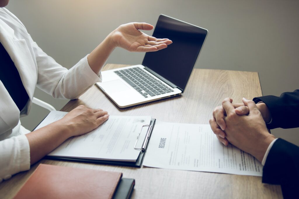 Female managers are talking about the recruitment of staff at the office.